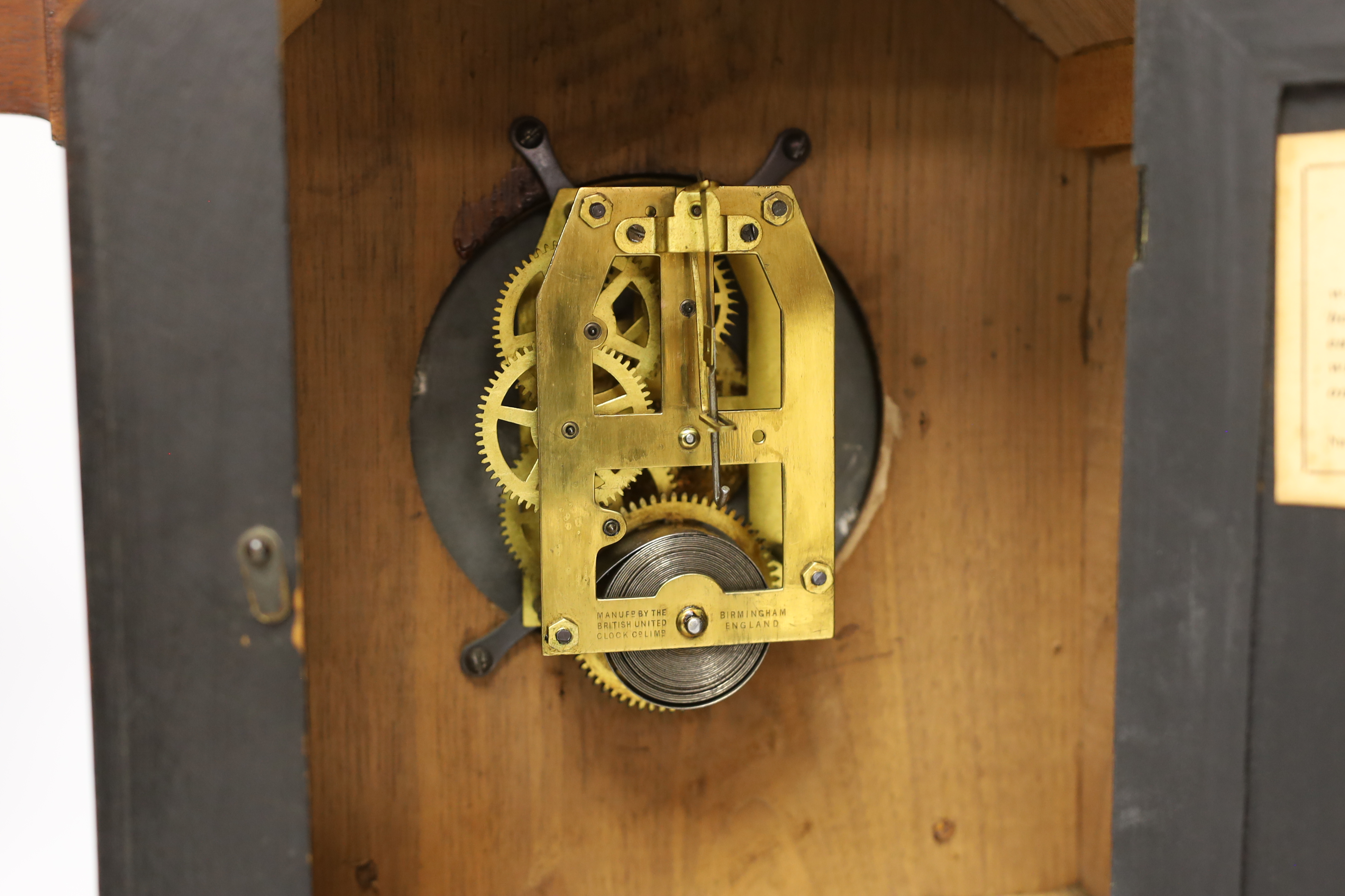 A carved wood clock with barometer, thermometer and compass, 52cm high